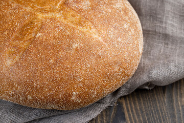 A whole loaf of round-shaped wheat bread