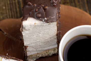 Fresh sweet cake with milk taste and aroma in chocolate glaze