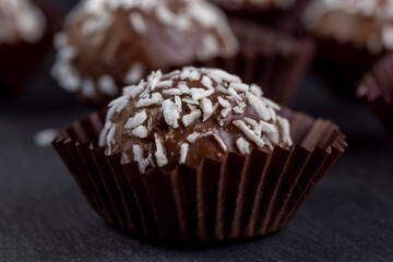 Chocolate candies in the form of balls with milk coconut