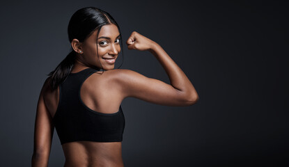 Portrait, smile and woman flexing back in studio isolated on a black background mockup. Strong flex, happy and Indian female athlete with bicep, arm strength or bodybuilder muscle, fitness or workout