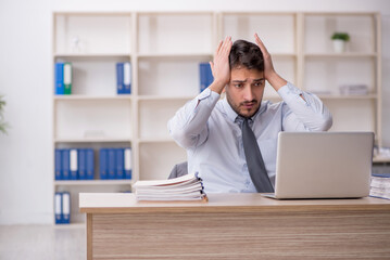 Young male employee working in the office