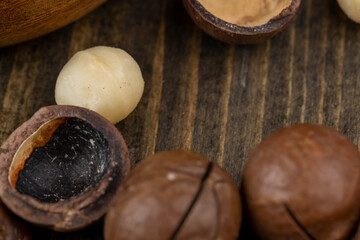 Fototapeta na wymiar Unpeeled macadamia nuts on the table