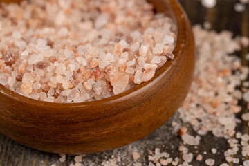 Pink natural salt on the table, close up