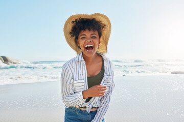 Woman, laughing and portrait in summer at beach for a vacation, travel or holiday with a smile. Face of African female person at sea with happiness, freedom and funny mindset outdoor with a blue sky