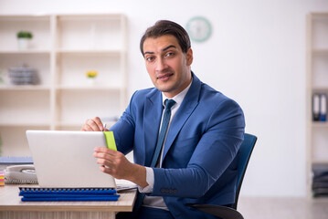 Young male employee working in the office