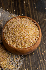 Fresh wheat porridge in a wooden bowl