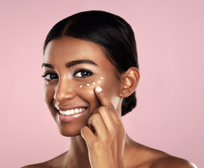 Smile, skincare and face of woman with cream in studio isolated on a pink background. Dermatology,...