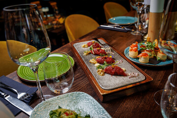 Pieces of beef tartare on a plate in a restaurant.