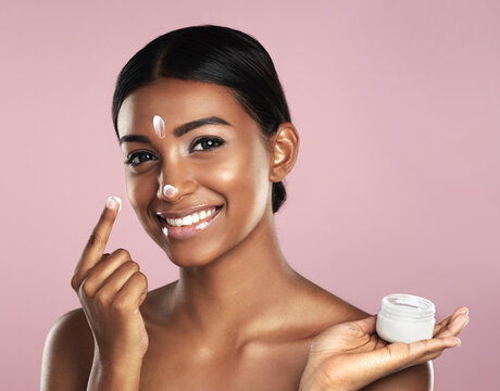 Skincare, Face And Woman With Cream Container In Studio Isolated On A Pink Background. Product, Dermatology Creme And Portrait Of Happy Indian Female Model Apply Lotion, Moisturizer And Cosmetics.