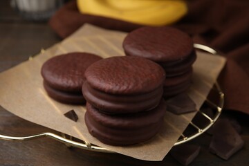 Delicious choco pies on wooden table, closeup