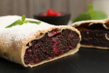 Delicious strudel with cherries on board, closeup