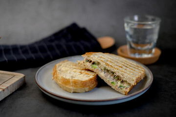 Grilled tuna sandwich with avocado. Healthy, eating diet and dinner meal concept made with sourdough and cucumber.