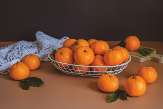 the still life of orange, or a mandarin on black background.
