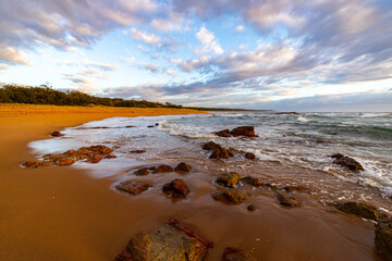 colorful sunrise on the wreck rock beach in deepwater national park near agnes water and town of...