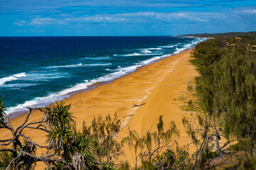 panorama of beautiful long beach with orange sand in deepwater national park south from agnes water and seventeen seventy; unique coast of gladstone region in queensland, australia;