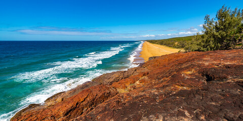 panorama of beautiful long beach with orange sand in deepwater national park south from agnes water and seventeen seventy; unique coast of gladstone region in queensland, australia; - obrazy, fototapety, plakaty