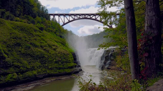 Letchworth State Park with Upper Falls and Bridge Slow. Wide shot of the upper falls at Letchworth State Park under a bridge in slow motion