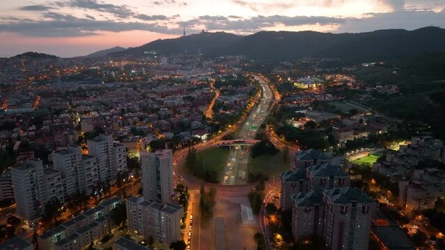 Aerial view of Barcelona city skyline at night, Streets with busy car traffic and city lights. Nou Barris District and Ronda de dalt, Catalonia, Spain