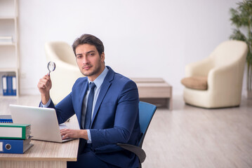 Young male employee working in the office