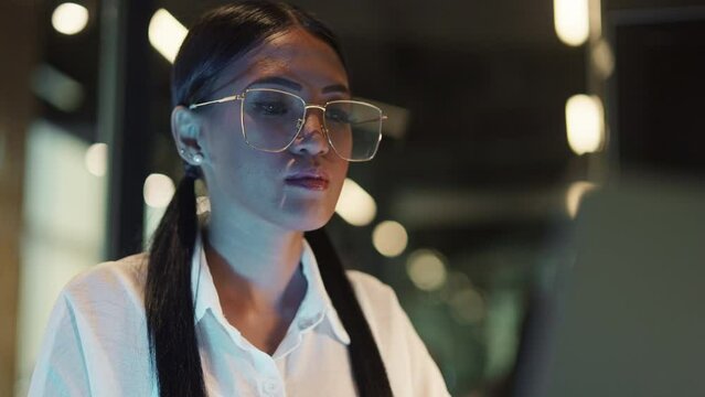 Close-up Of A Woman Working Closely On Her Laptop