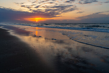 Fototapeta na wymiar Colorful Seaside Sunrise on a Cloudy Morning