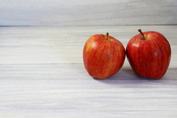 red apple fruit isolated on gray wooden background,selective focus with copy space
