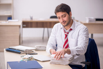 Young male employee working in the office