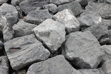 Coastal reinforcement with large granite rocks at seashore