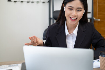 Video call communication lead asian leader talk to colleagues work from home office wear headphones express opinion offer solution at virtual meeting. Student use pc and internet e-learning remotely