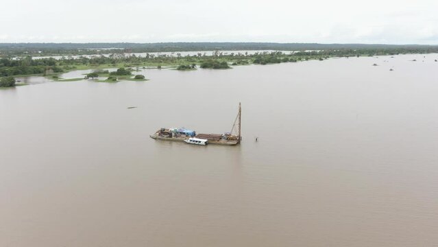 Aerial view around floating workstation, constructing a eletric tower in the middle of the Amazon river