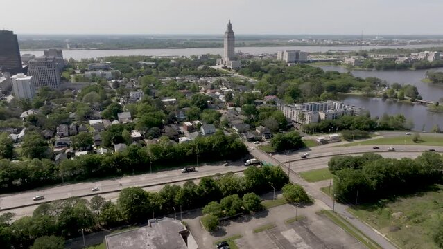 Freeway traffic with Baton Rouge skyline and Louisiana state capitol building with drone video panning right to left.