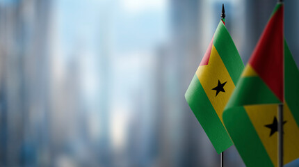 Small flags of the Sao Tome and Principe on an abstract blurry background