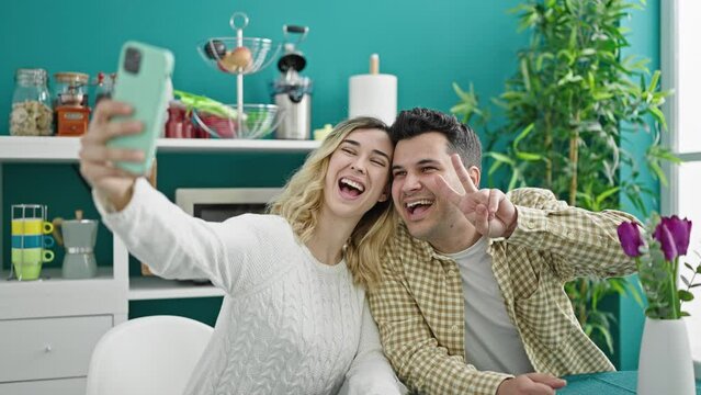 Man and woman couple sitting on table make selfie by smartphone at dinning room