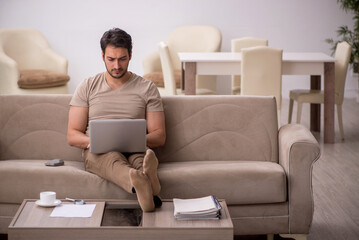 Young male freelancer working from home during pandemic