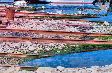 Ship launching rails at edge of water at seaport.