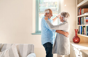 Elderly couple, dancing and home living room with smile, happiness or love for care, support or laugh. Senior man, excited old woman or dance together in house with romance, comic bonding and space