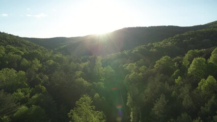 Aerial push in on sunset in Appalachian mountains in North Carolina near Asheville in spring time - Powered by Adobe