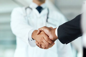 Closeup, doctor or man with handshake, negotiation or planning with partnership, healthcare or...