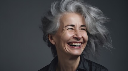 Portrait of a beautiful senior woman smiling at the camera on a gray background.Generative Ai