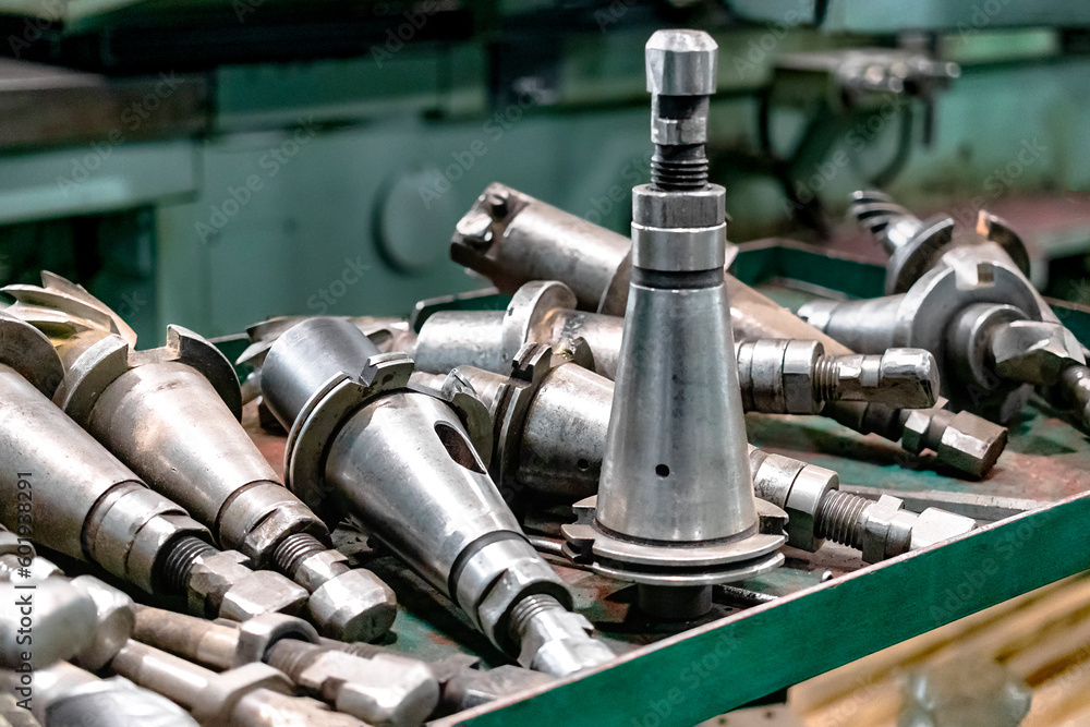 Poster a set of milling cutters on a rack near a lathe. metalworking cutting mills for cnc machines. indust