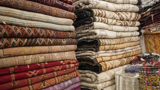 High quality carpets made in Morocco for sale in market, handheld view