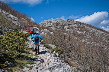 Fototapeta na wymiar Senior couple hiking in karst landscape in Croatia