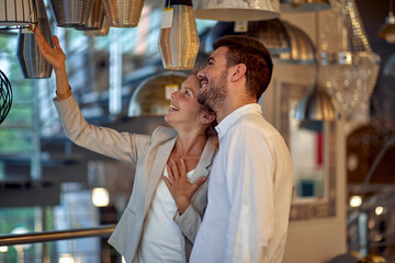 Couple Admiring Lighting Fixtures in Store