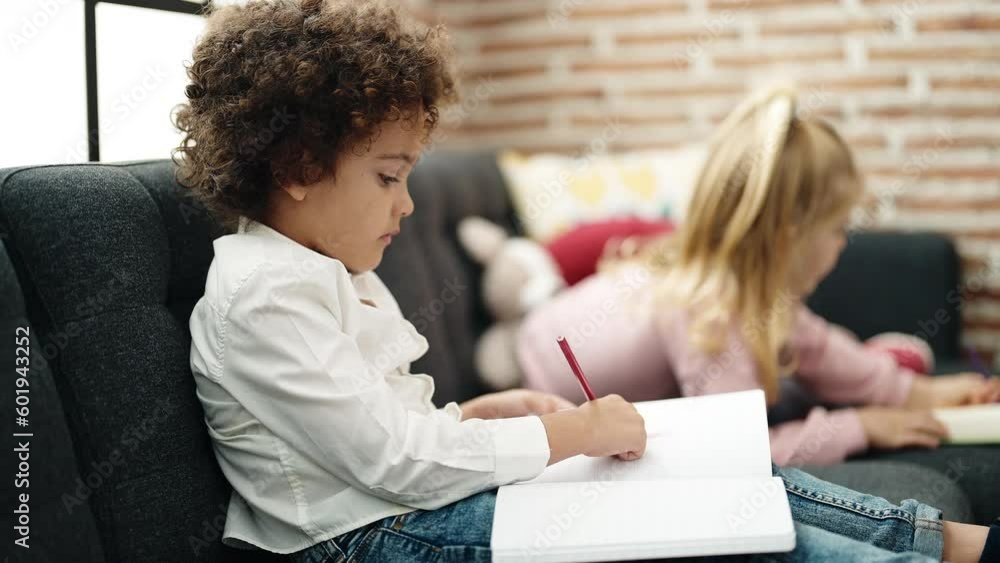 Sticker adorable boy and girl students sitting on sofa drawing on notebook at home