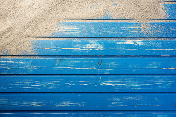 Blue weathered wood plank background with beach sand