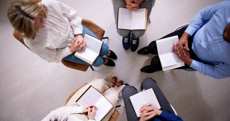Group Of People Reading Religious Book