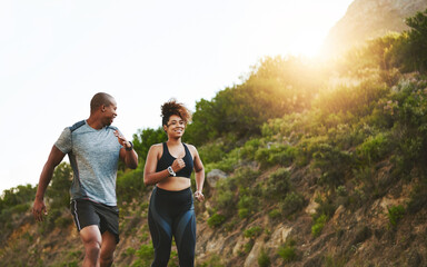 Fitness, nature and couple walking by a mountain training for a race, marathon or competition. Sports, exercise and African athletes or runners doing outdoor running cardio workout together at sunset