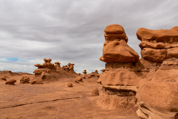 Fototapeta na wymiar Close up view on unique eroded Hoodoo Rock Formations at Goblin Valley State Park in Utah, USA, America. Sandstone rocks called goblins which are mushroom-shaped rock pinnacles. Overcast day in summer