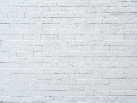 Brick wall and white surface, clean, rough, uneven surface material. Retro decoration construction.