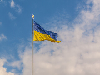 Flag of Ukraine with a trident in the blue sky